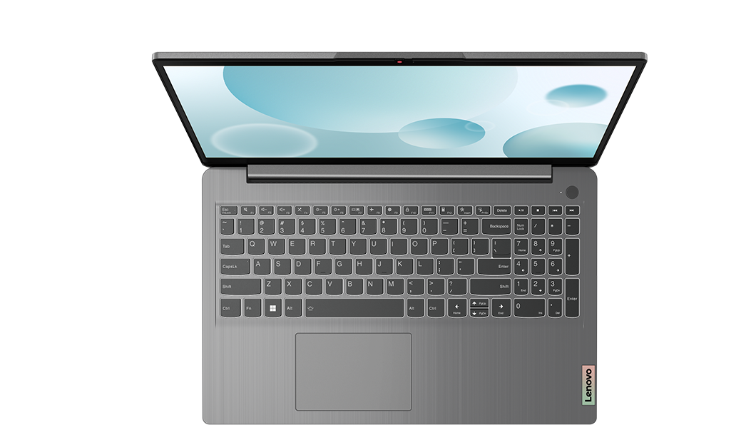 Portátil gris con teclado y pantalla abierta sobre fondo negro.
