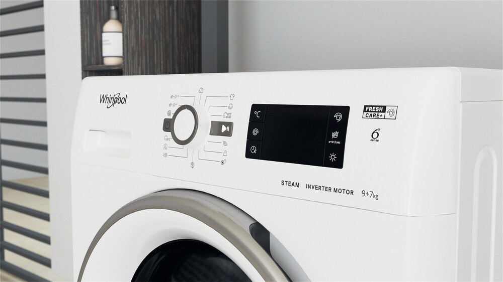 Biały panel sterowania pralki z przyciskami, pokrętłem i ekranem. Widoczne 'Whirlpool' i 'Steam'.