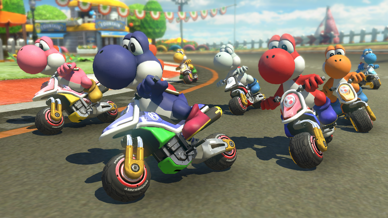 Several Yoshis on motorcycles race on a track in a video game.
