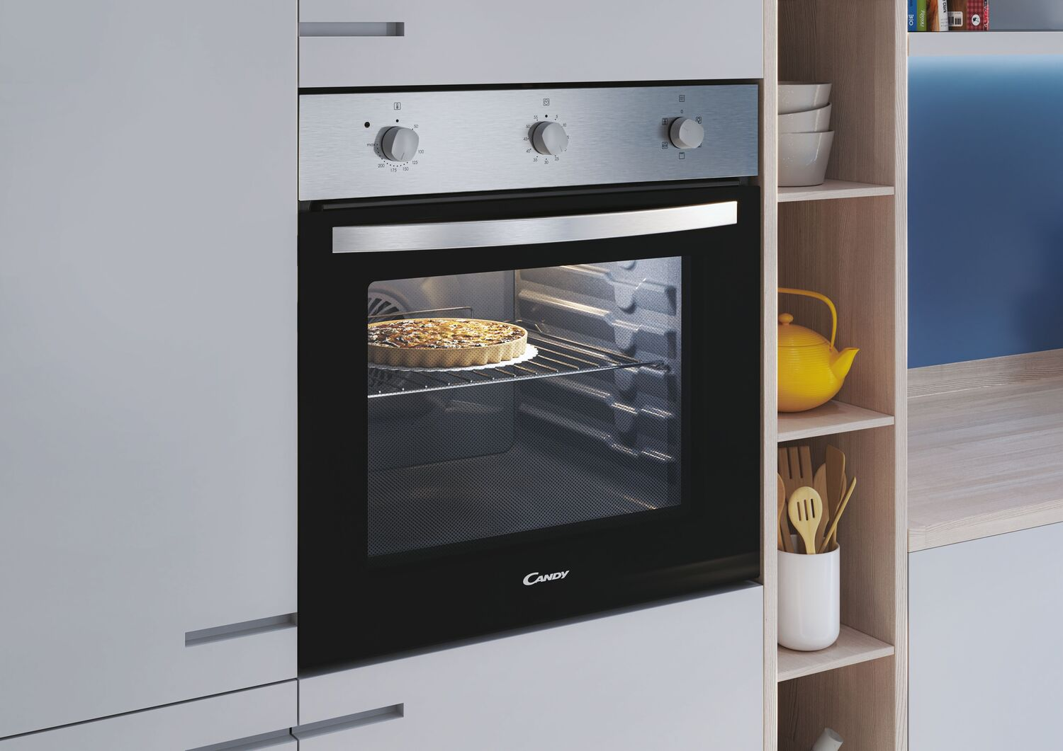 Un horno con un pastel dentro. Las perillas están en la parte superior, un estante a un lado.