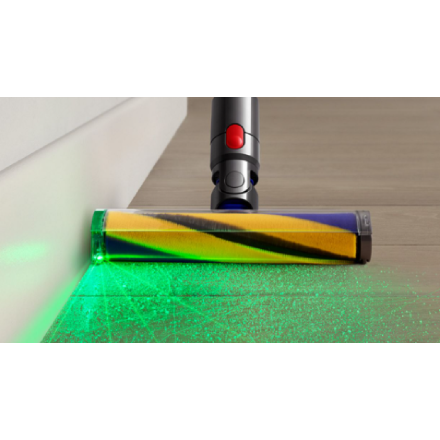 A vacuum cleaner head with a green laser light. The cleaner is on a wood floor, and the light shines.