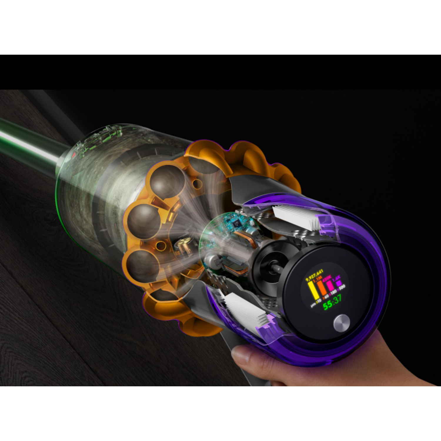 A hand holds a Dyson vacuum cleaner. It shows the internal components with a display.
