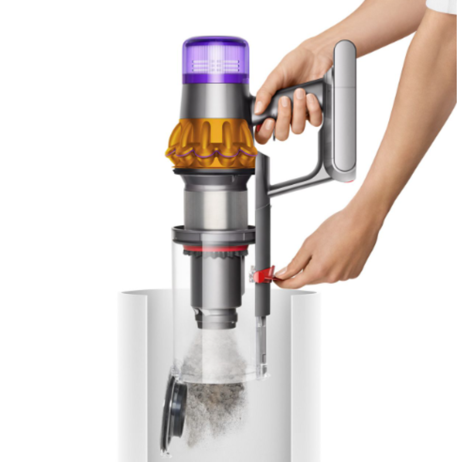 A person emptying a vacuum cleaner dust container into a white trash can.