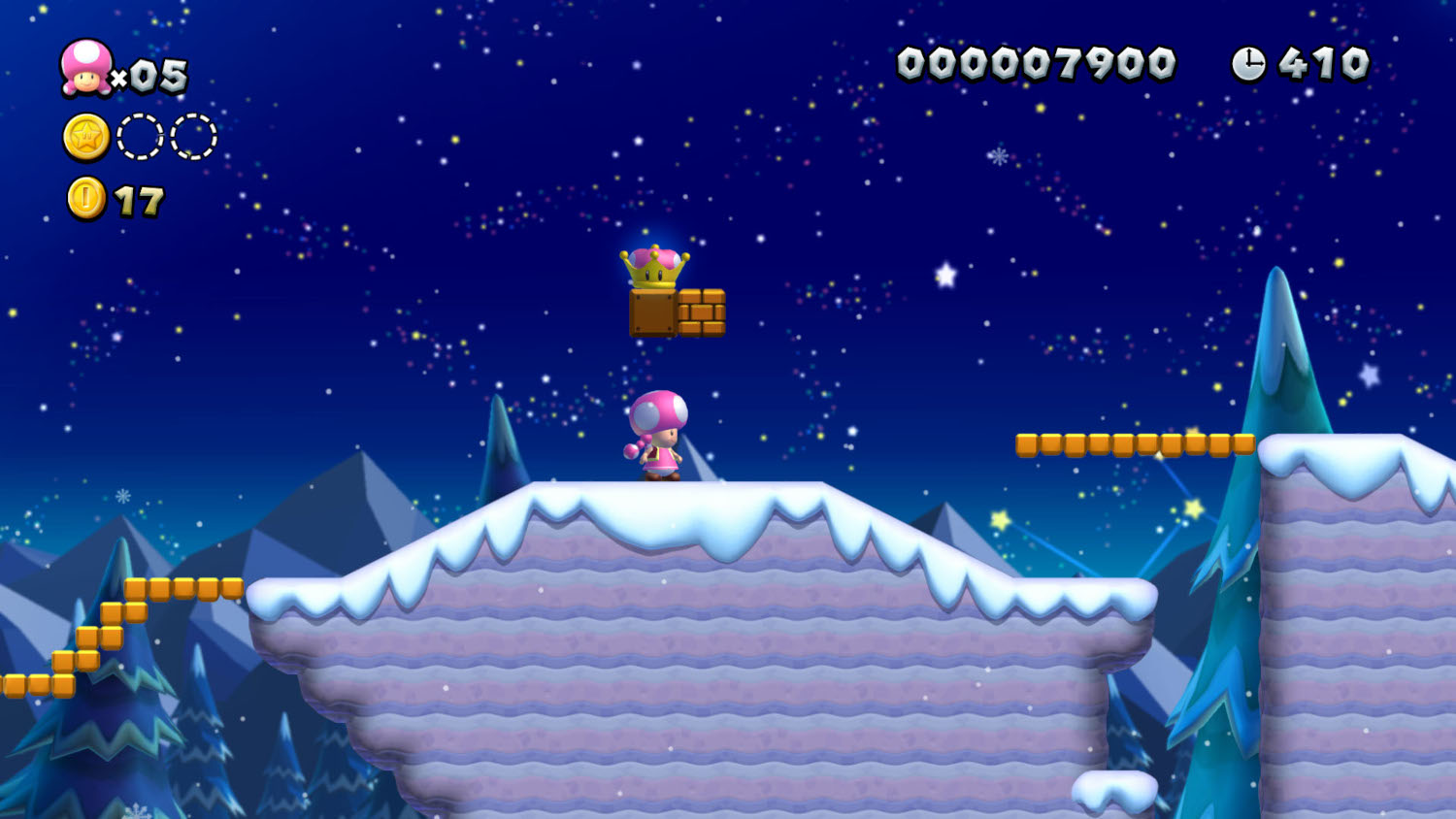 Toadette op een besneeuwd platform, met een kroon erboven.