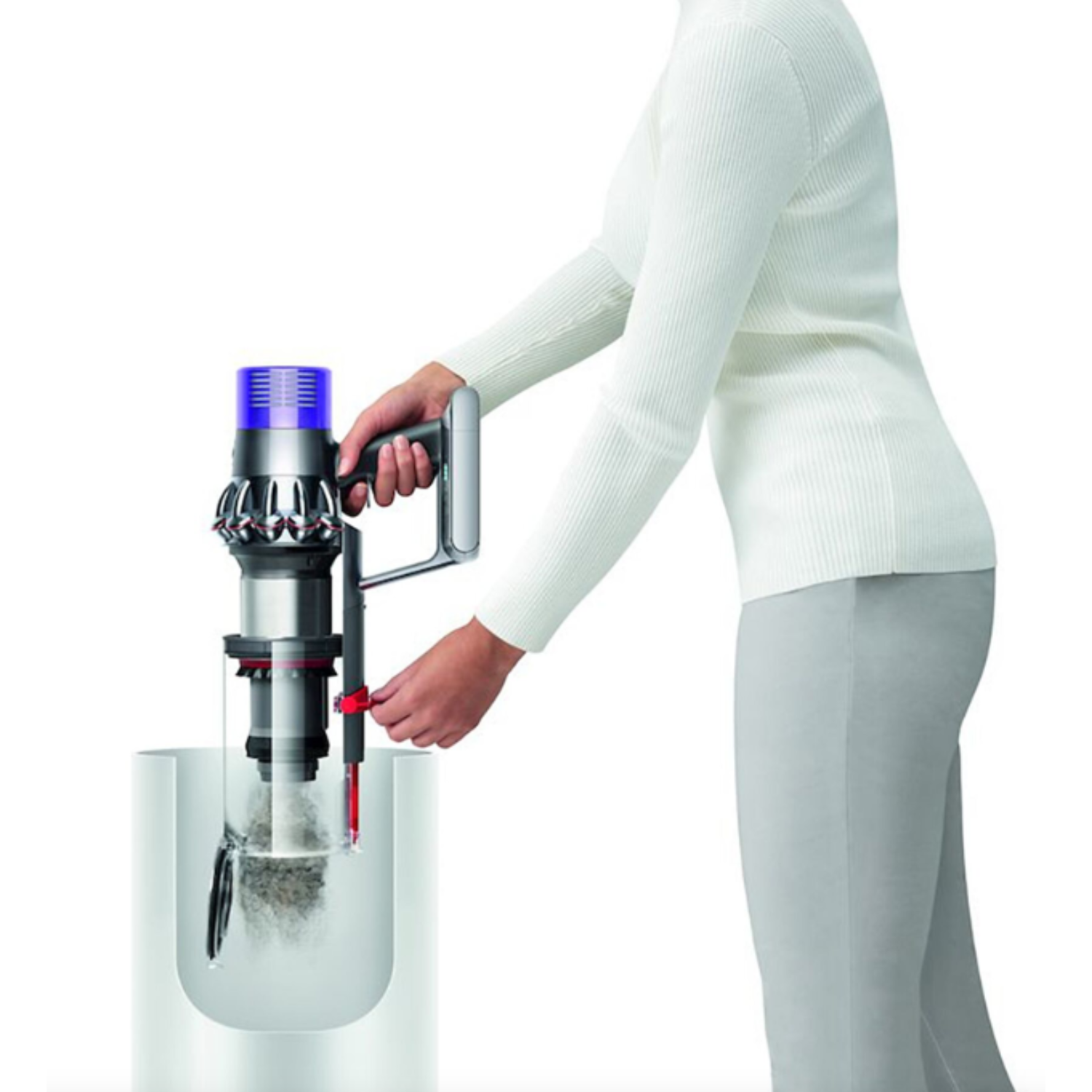 Person emptying a vacuum cleaner into a container; visible vacuum parts.