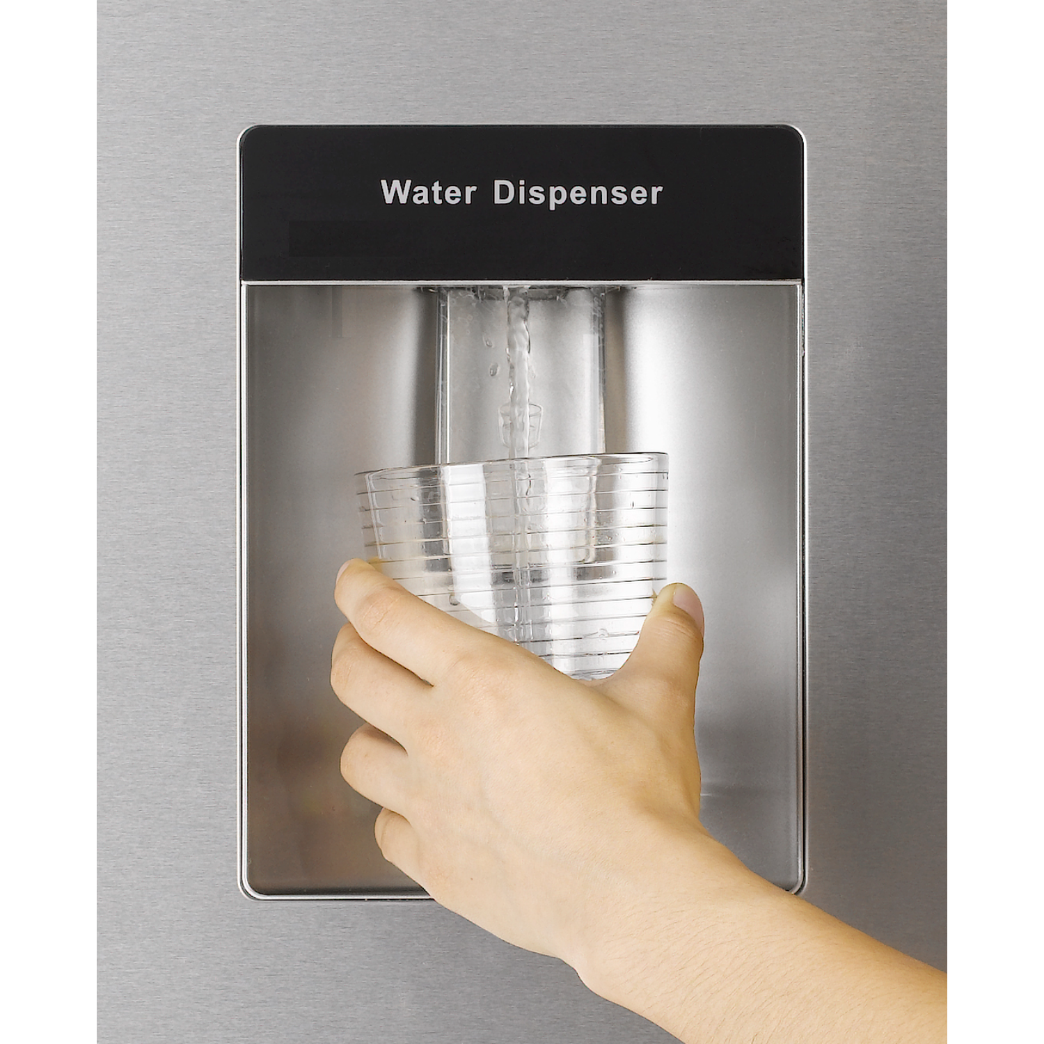 A hand filling a glass with water from a stainless steel water dispenser.