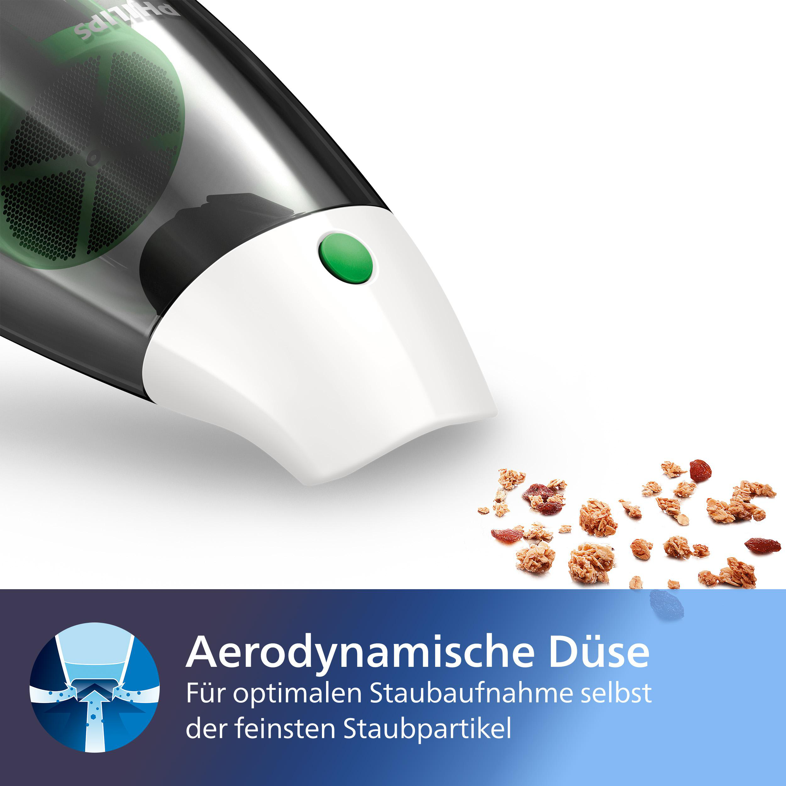 Nahaufnahme einer Staubsaugerdüse mit verstreuten Krümeln. Die Düse ist weiß und schwarz mit einem grünen Knopf.