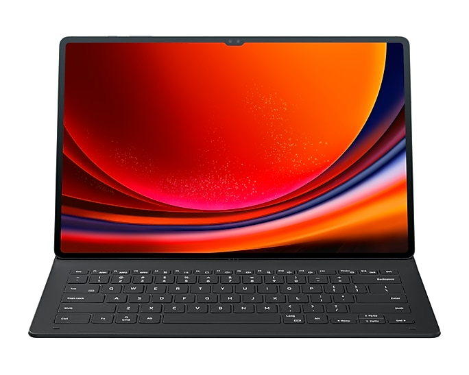 Una tableta negra con una funda de teclado, que muestra un fondo de pantalla abstracto colorido.
