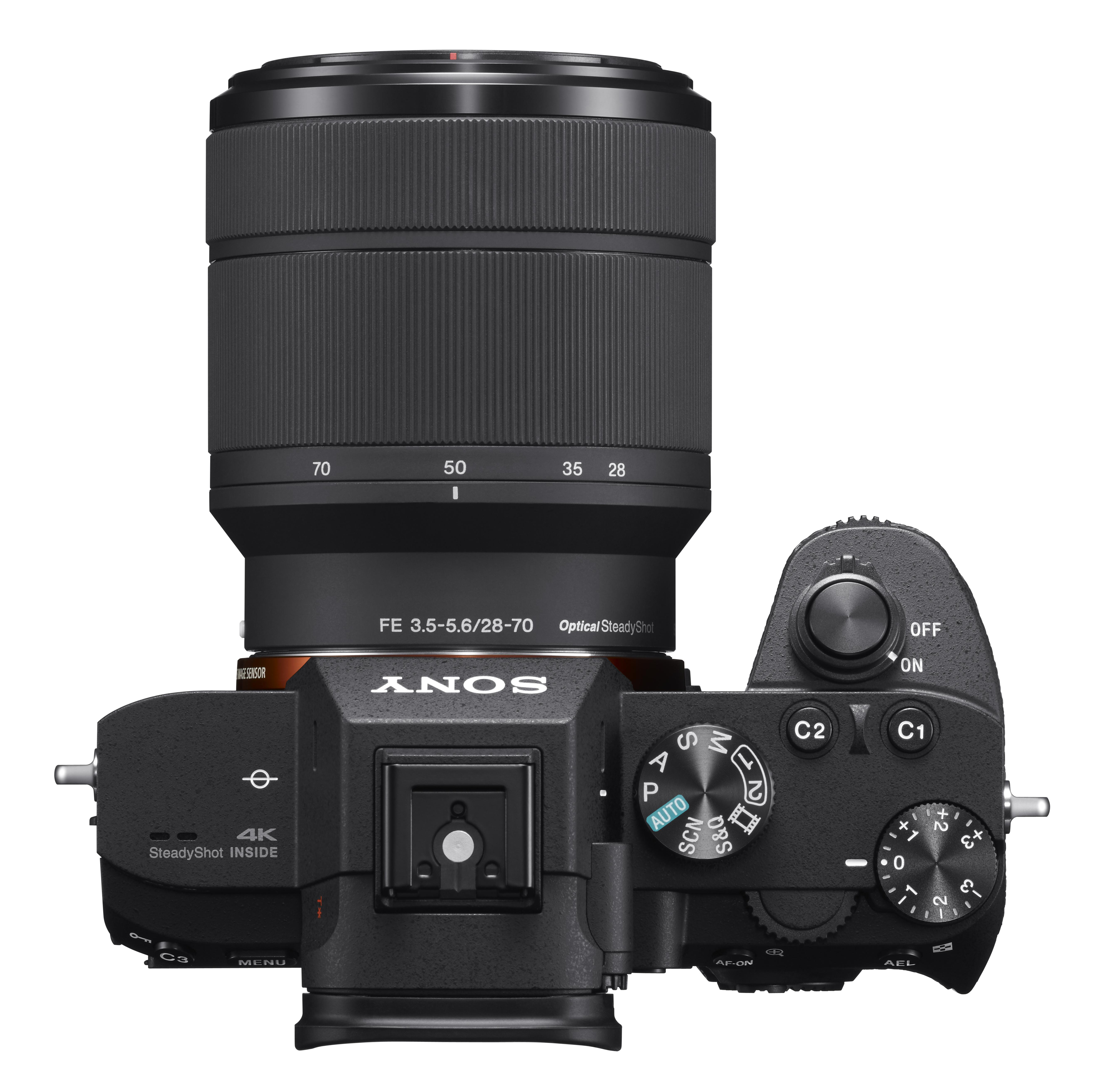 Draufsicht auf eine schwarze Sony-Kamera mit Objektiv. Verschiedene Drehknöpfe und Tasten sind sichtbar.