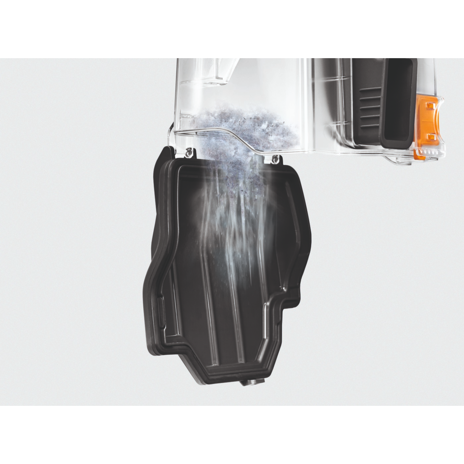 A filter is being emptied. Dust and debris falling into a black container.
