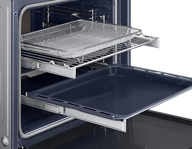 Wnętrze piekarnika z blachą do pieczenia i rusztem, oba lekko wysunięte.