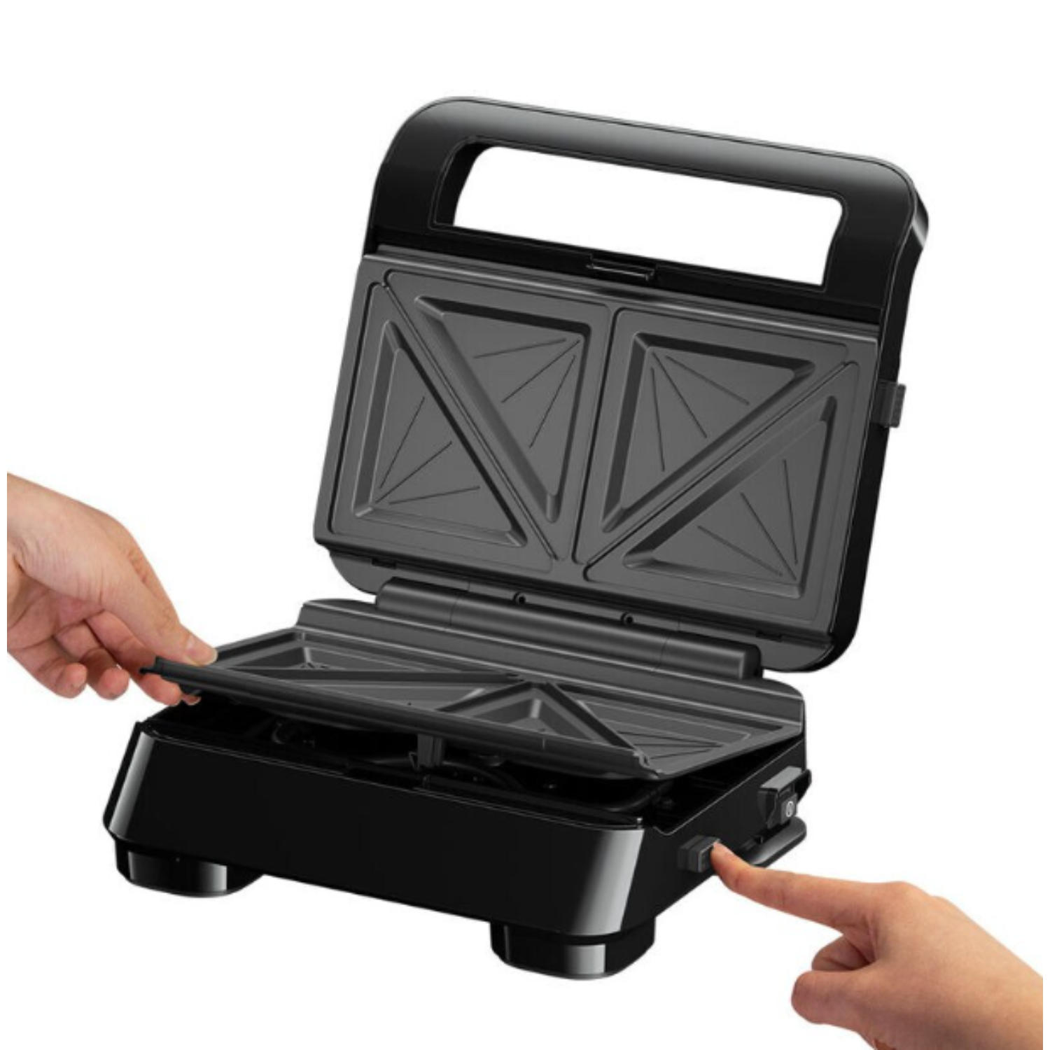Black sandwich maker, open, with hands operating the lid and power button.