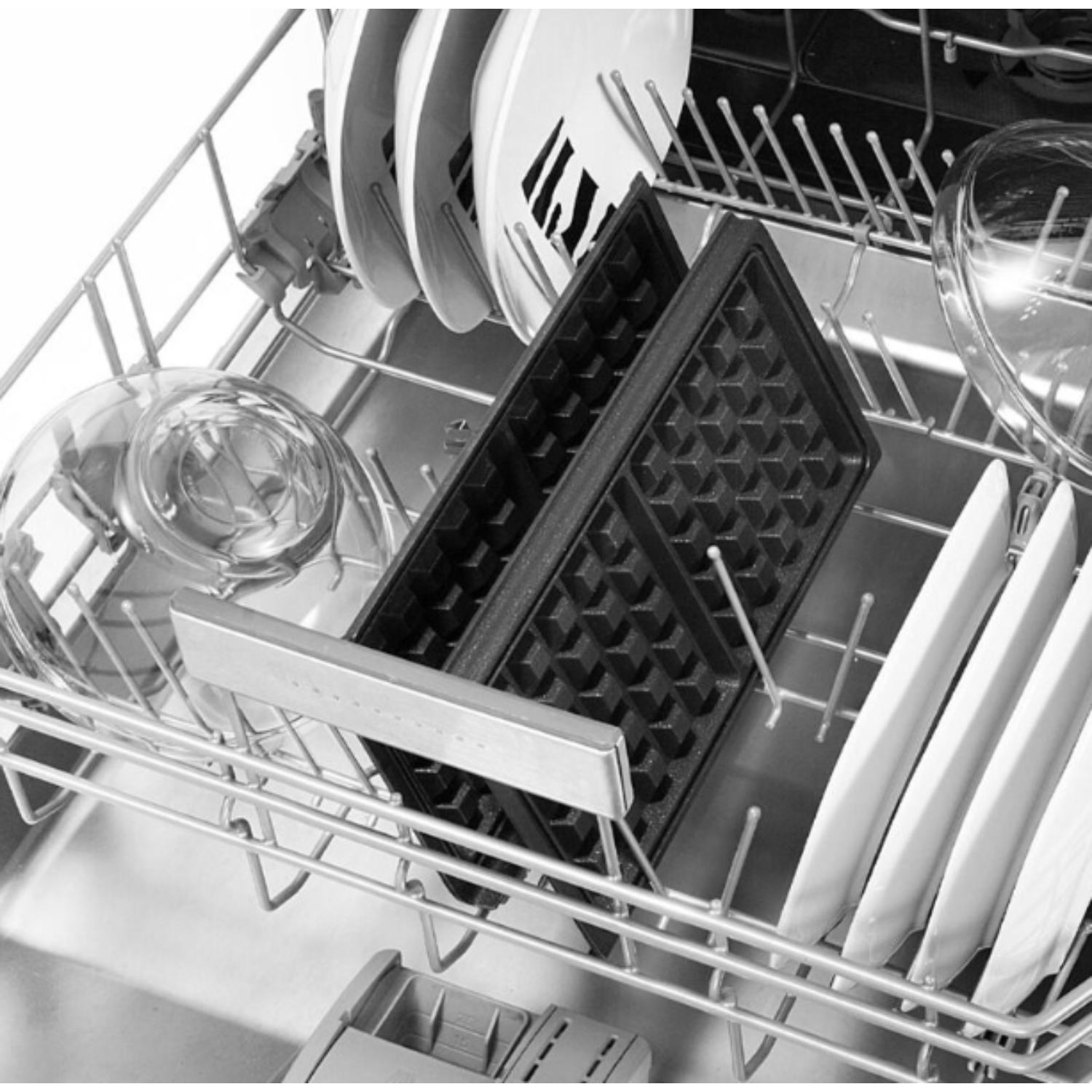 Dishwasher with dishes and a waffle iron. The waffle iron is black and in the center.