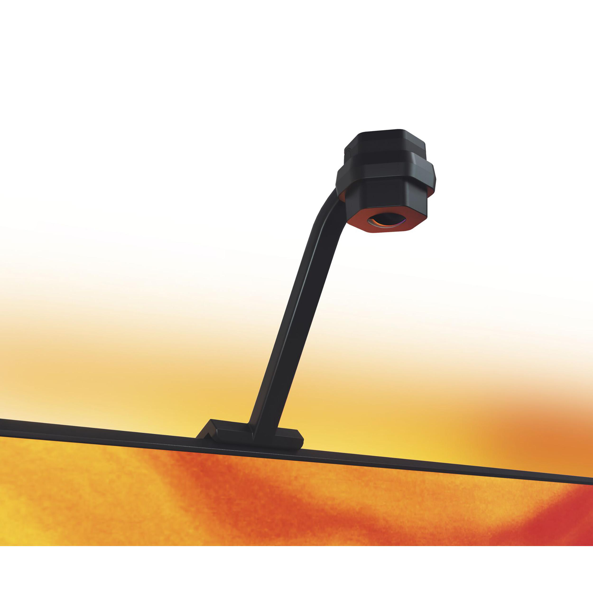 Ein schwarzes Gerät auf einem Ständer, mit einem schwarzen Arm. Der Hintergrund ist gelb und orange.