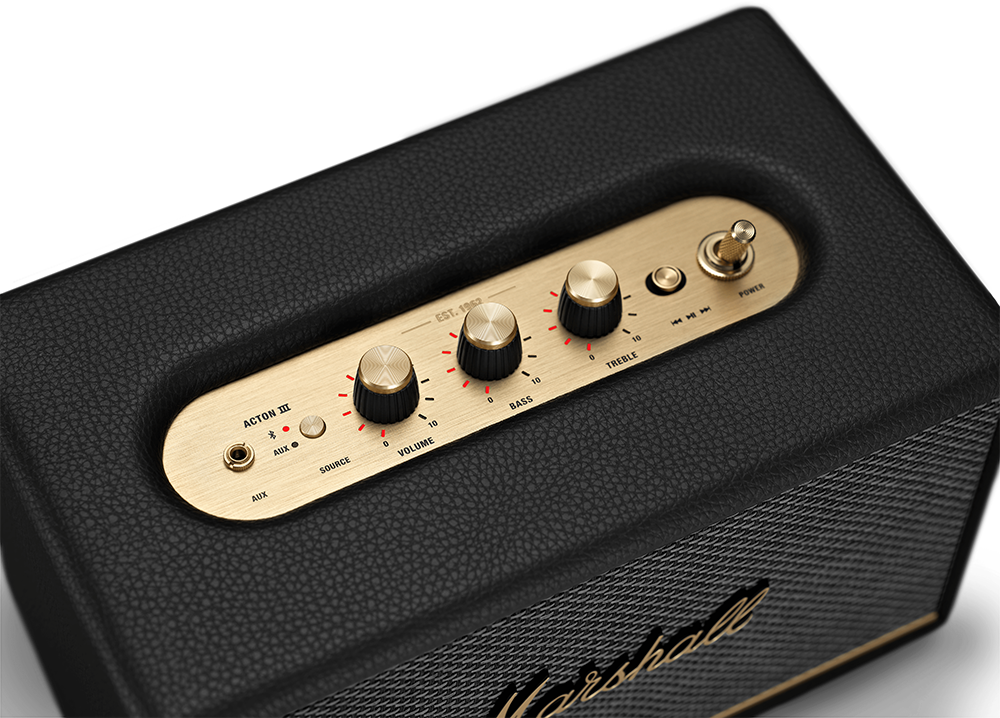 Black Marshall speaker, gold knobs, and a power switch on top.