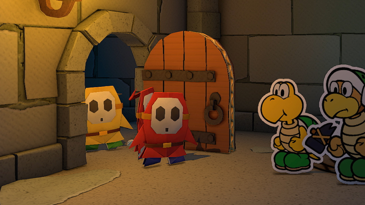Personnages de Paper Mario dans un couloir de château. Des Shy Guys rouges et jaunes et des Koopa Troopas.