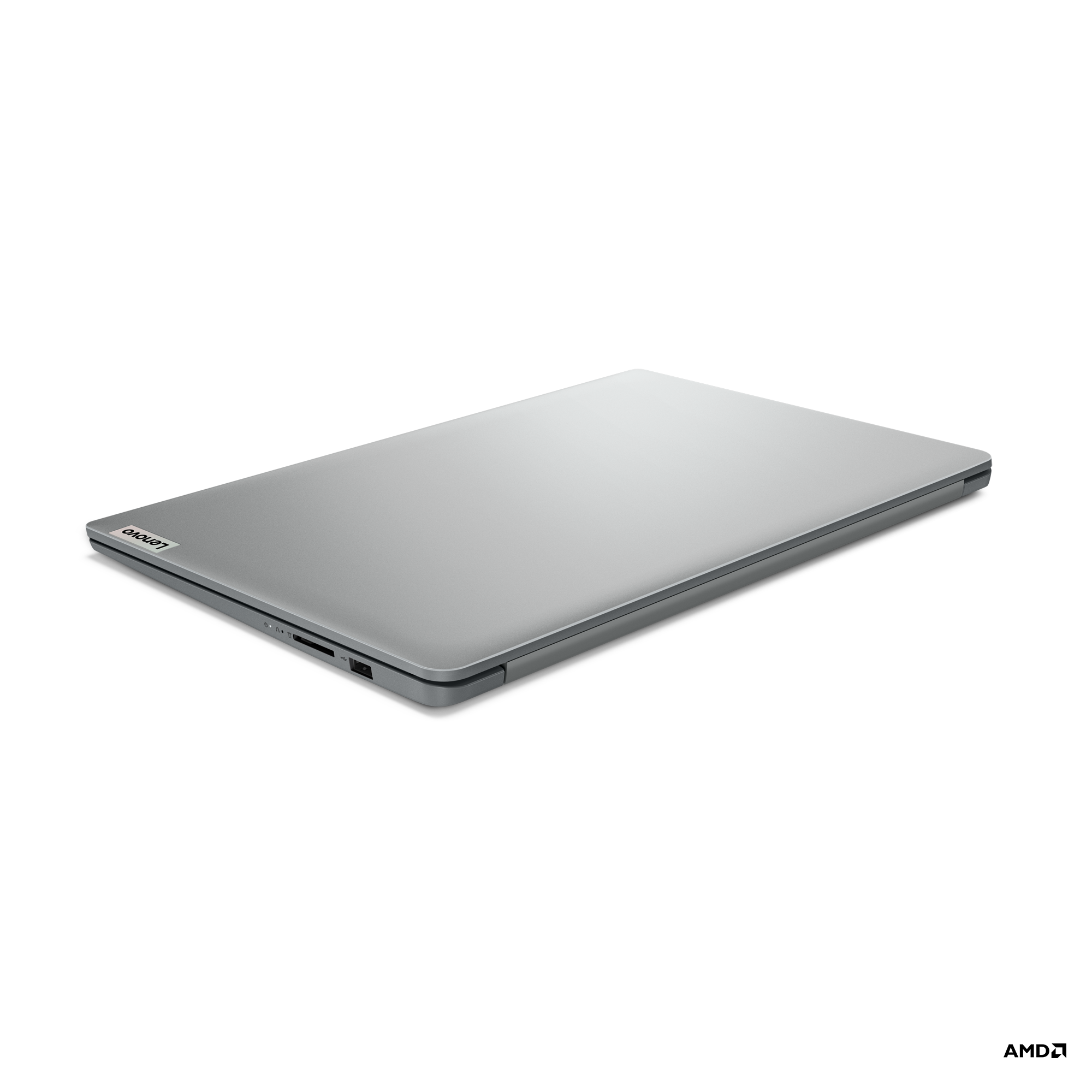 Siyah bir yüzey üzerinde kapalı gümüş bir Lenovo dizüstü bilgisayar. Lenovo logosu görünür.