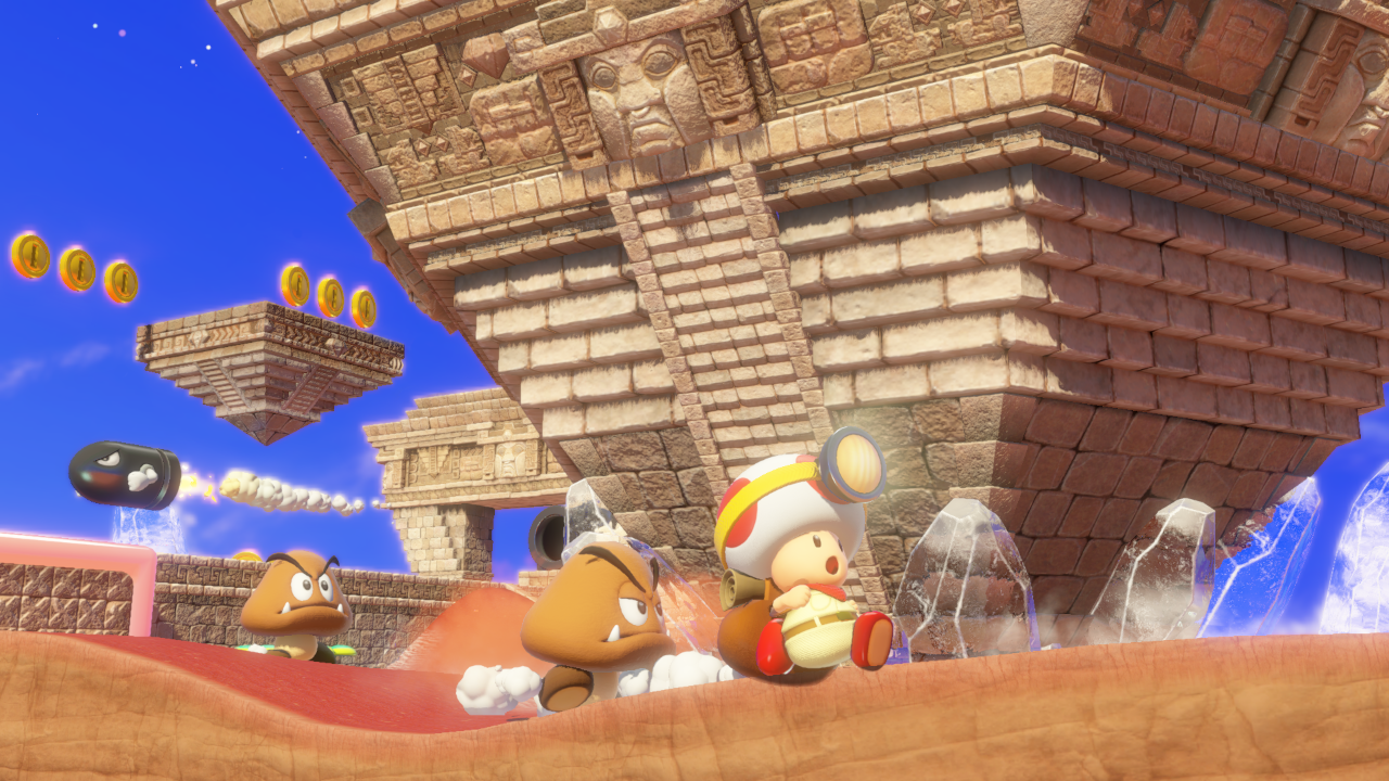 Videogame scène met Goombas, een Toad, en een grote stenen structuur.