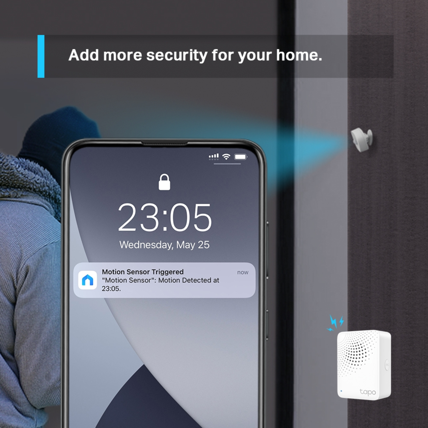 Phone with motion sensor alert. Burglar in background, Tapo device on the wall.