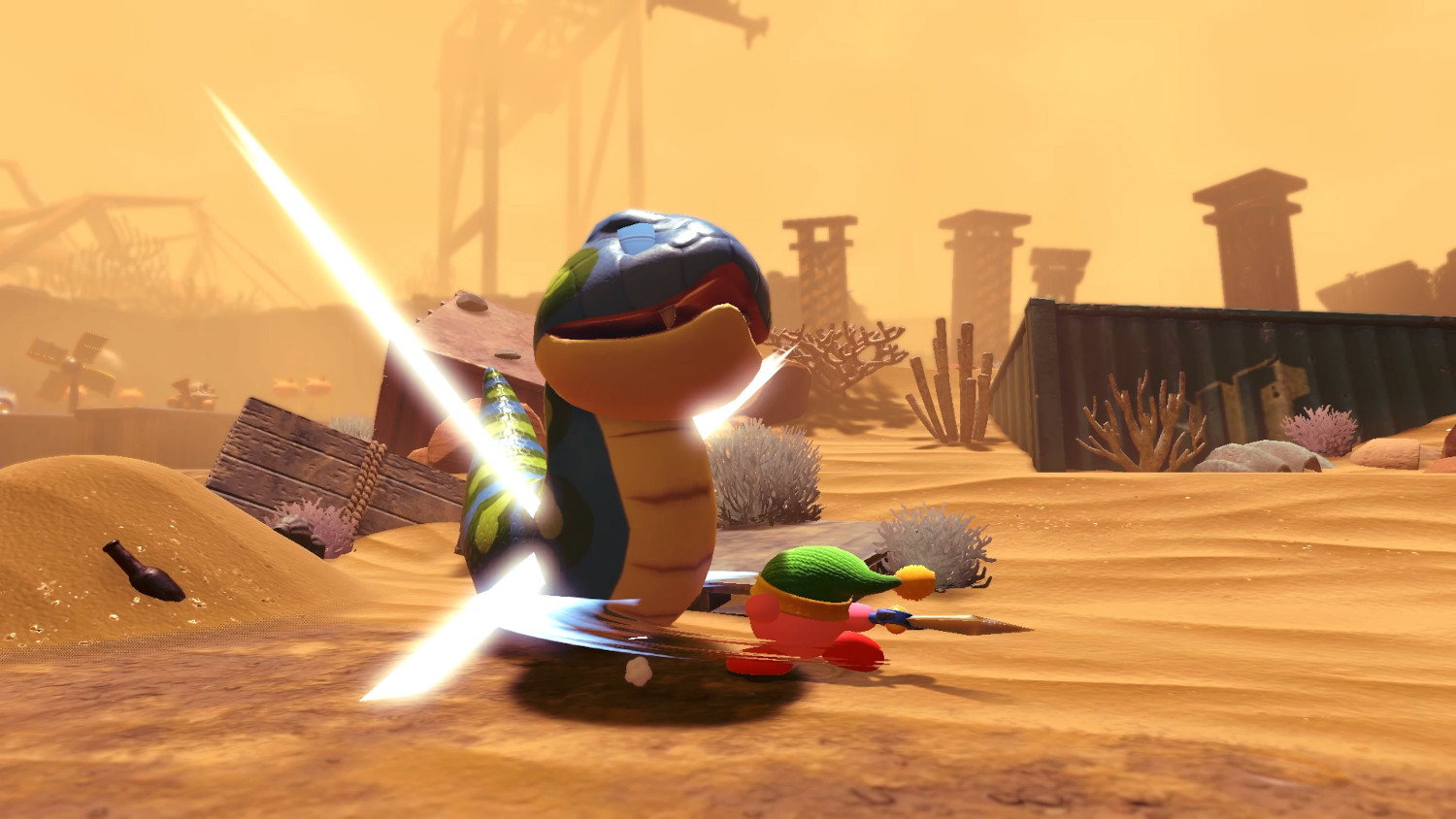 Kirby vecht met een zwaard tegen een monster in een woestijnomgeving. Het monster is een slang.