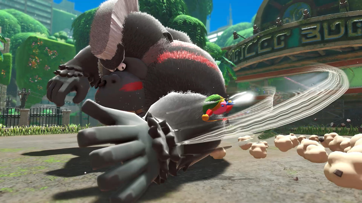 Een gorilla-achtig personage valt een Kirby-achtig personage aan in een videogame.