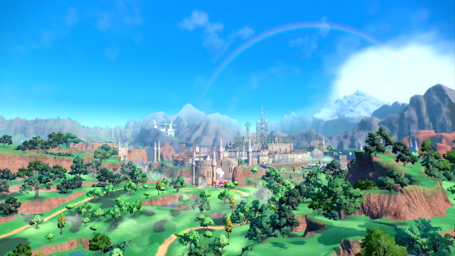 Een levendig landschap met een kasteel, bergen en een regenboog. Groene velden en bomen vullen de voorgrond.