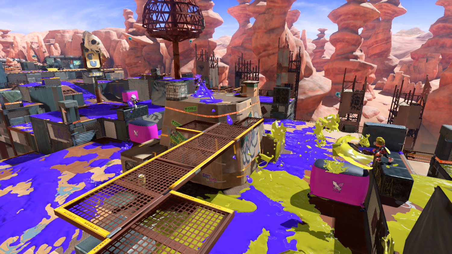 Een Splatoon 3 level, met inkt bedekt terrein en personages. Woestijnachtige omgeving.