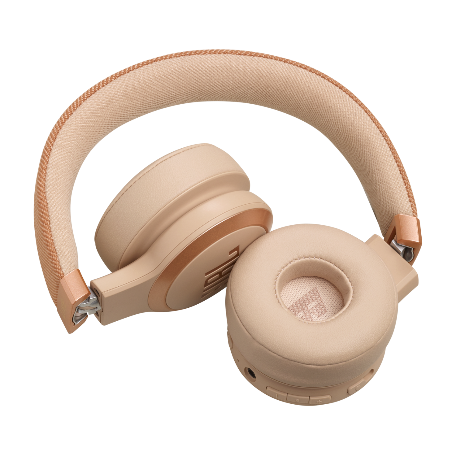 Tan colored headphones with a cushioned headband and ear cups, on a black background.