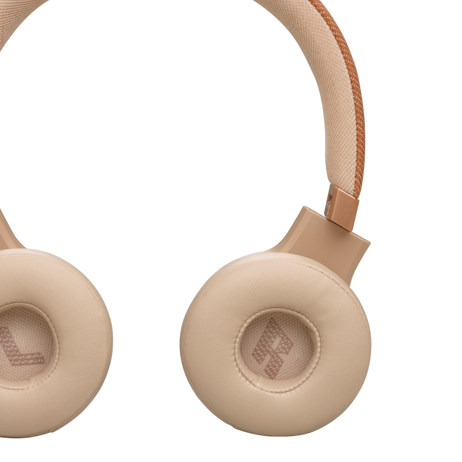 Close-up of tan-colored JBL headphones, showing earcups and headband.