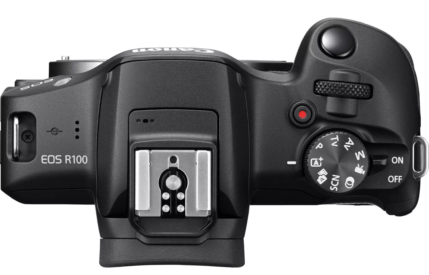 Aparat Canon EOS R100 z góry, pokazujący pokrętła i przyciski.
