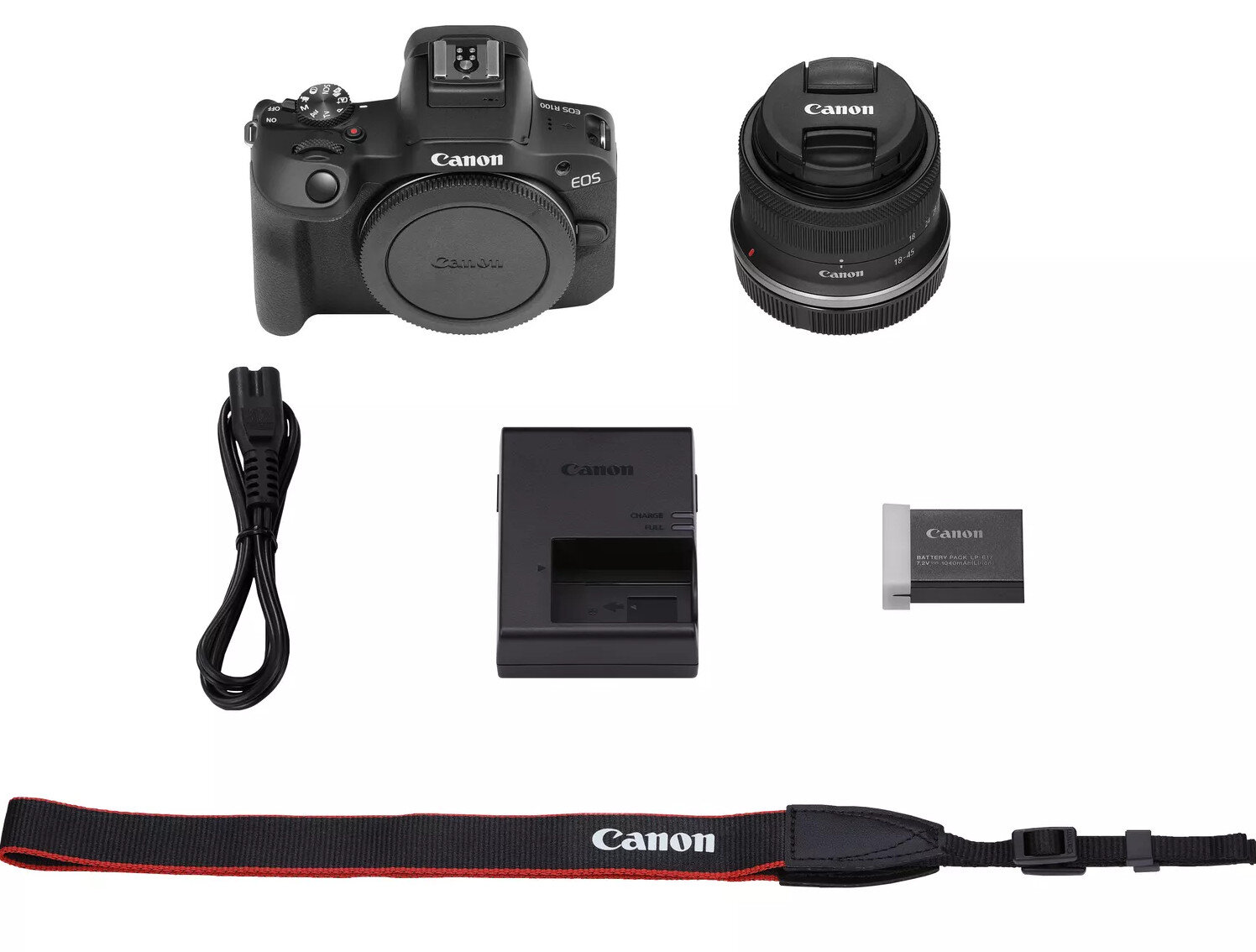 Zestaw aparatu na białym tle. Zawiera aparat, obiektyw, ładowarkę, baterię, pasek.