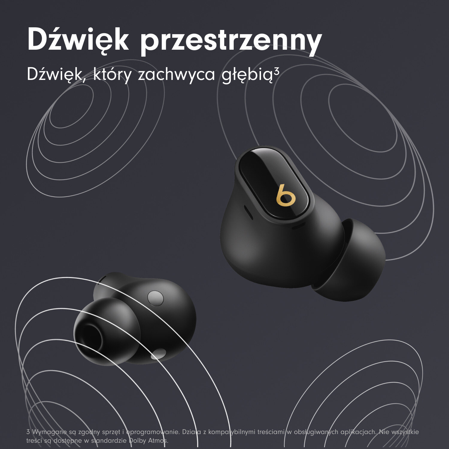 Czarne bezprzewodowe słuchawki z złotym logo 'b' na ciemnoszarym tle. Białe linie fal dźwiękowych.