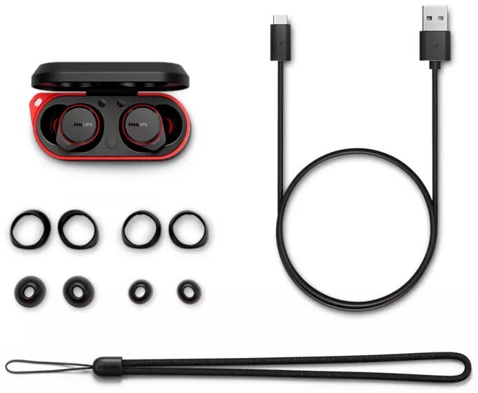 Słuchawki, etui ładujące i akcesoria, w tym końcówki i kabel do ładowania. Czerwone i czarne.