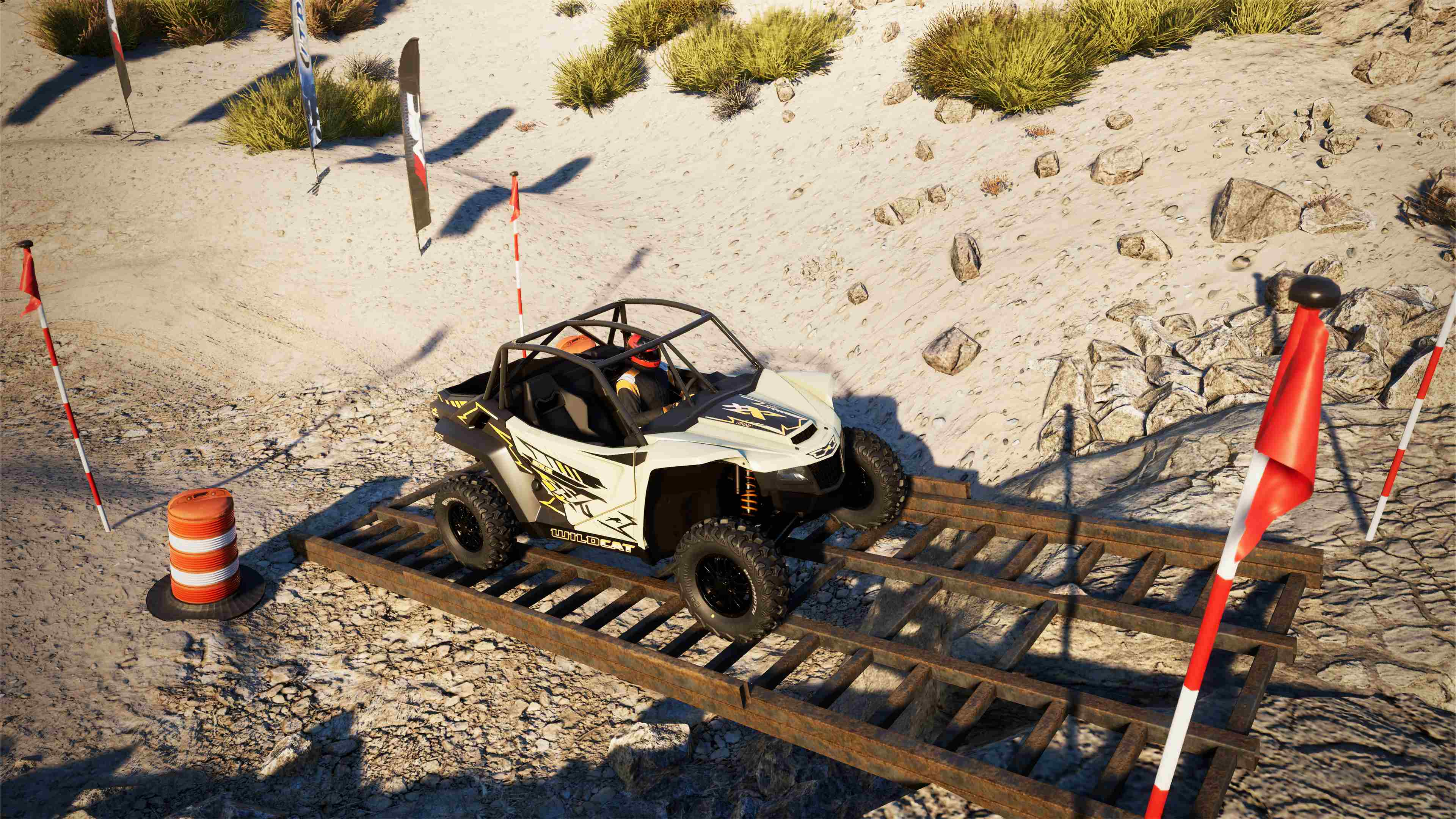 Un buggy blanc sur une piste avec des drapeaux dans un environnement désertique.