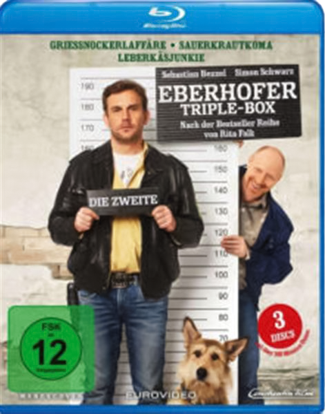 DVD-Cover mit drei Personen, einem Hund und Text. Der Titel lautet "Eberhofer Triple-Box".