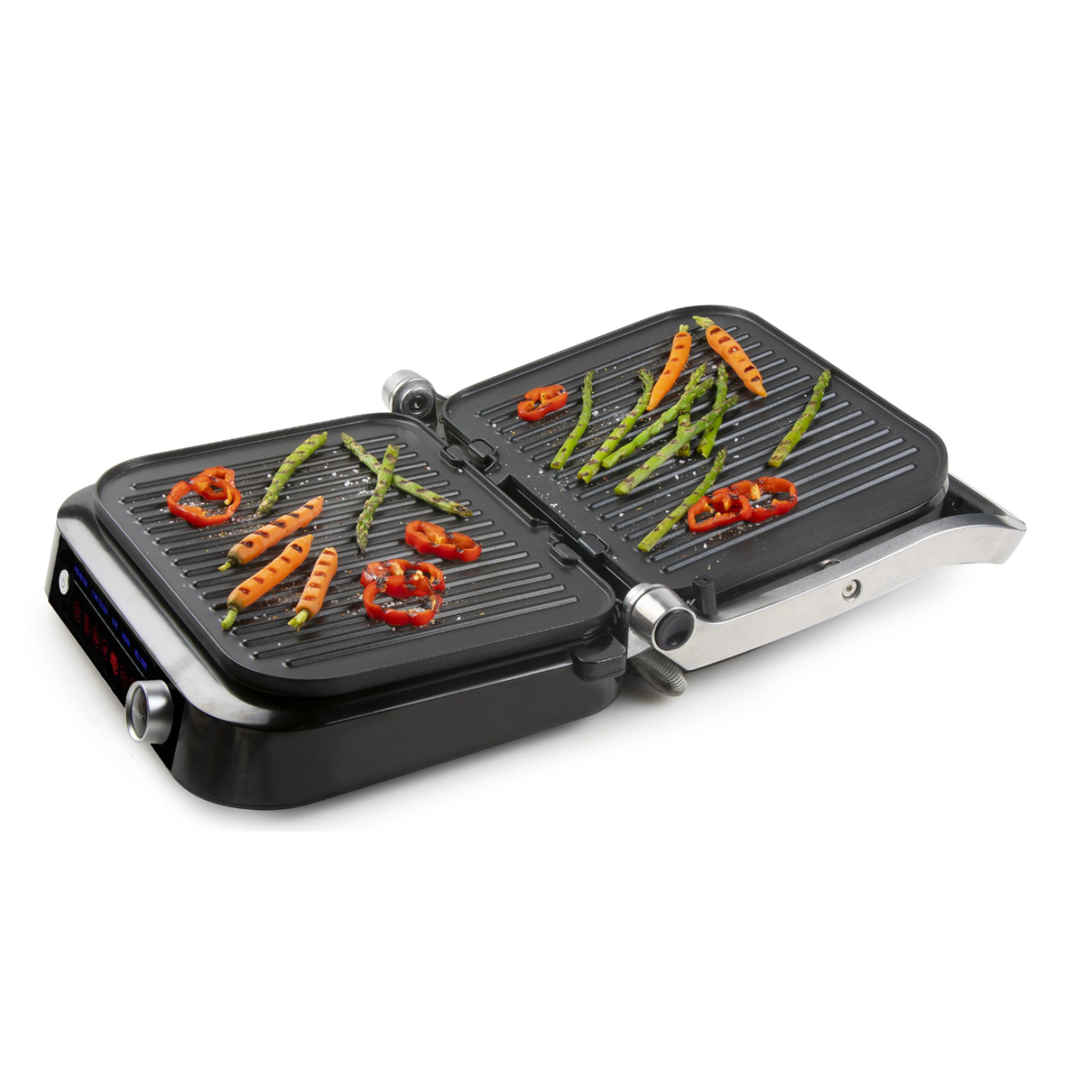 Open electric grill with vegetables cooking. Carrots, asparagus, and peppers.