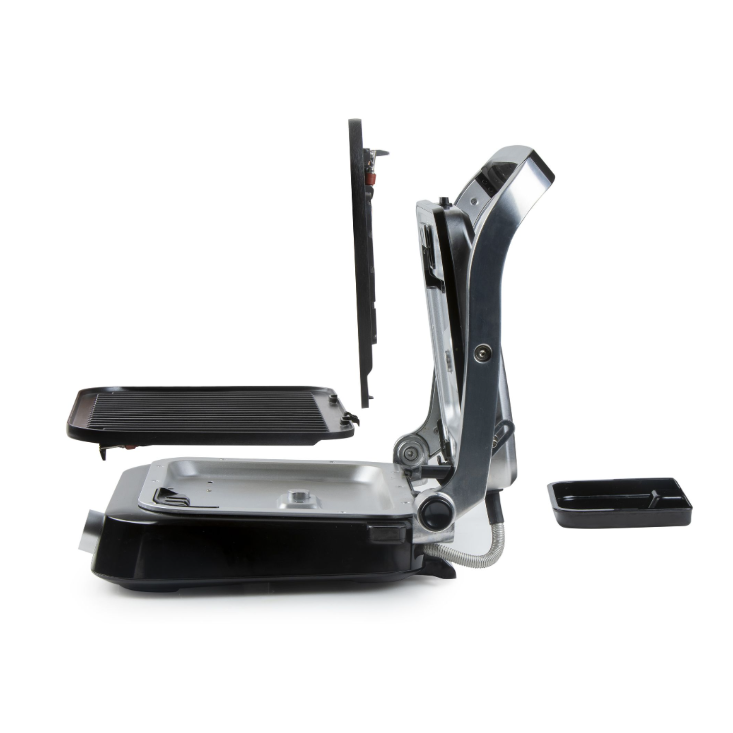 A disassembled grill has different parts like plates and a frame, against a white background.