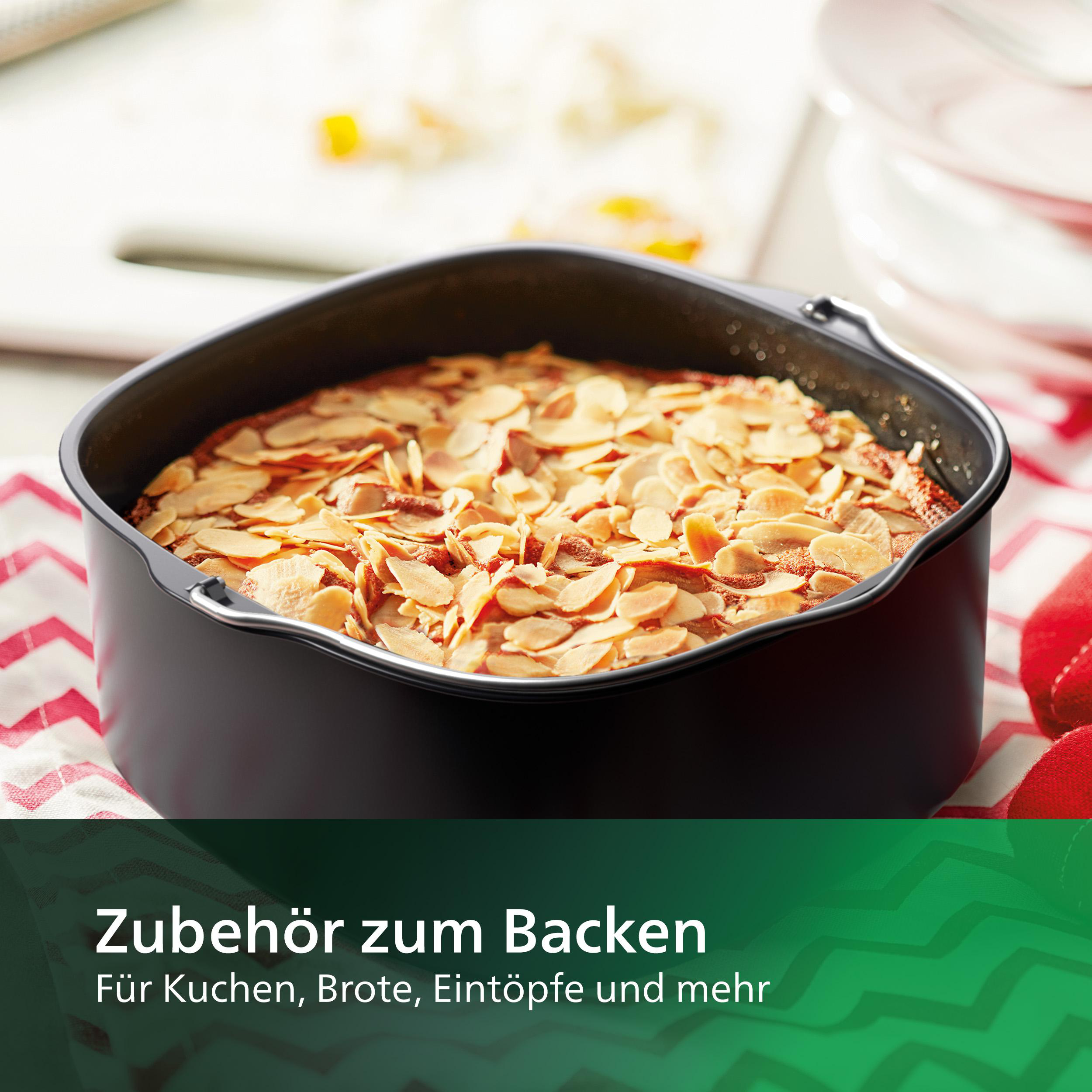 Schwarzes Airfryer-Zubehör mit Kuchen und Text auf weißer Oberfläche.