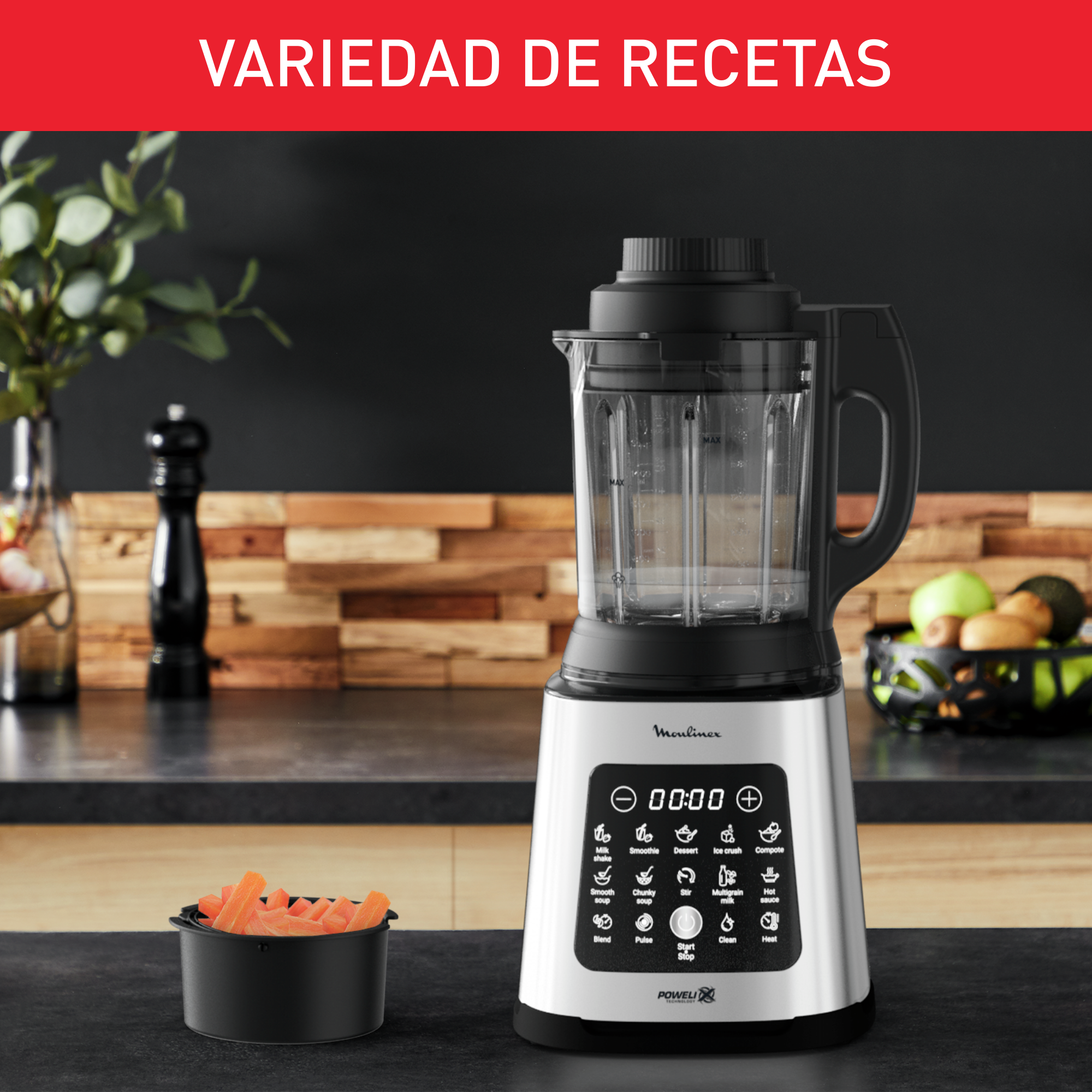 Una licuadora con base negra y un recipiente. Hay un cuenco de zanahorias a la izquierda.