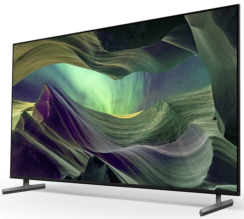 Duży ekran telewizora wyświetlający malowniczy krajobraz, z czarną ramką i białym tłem.