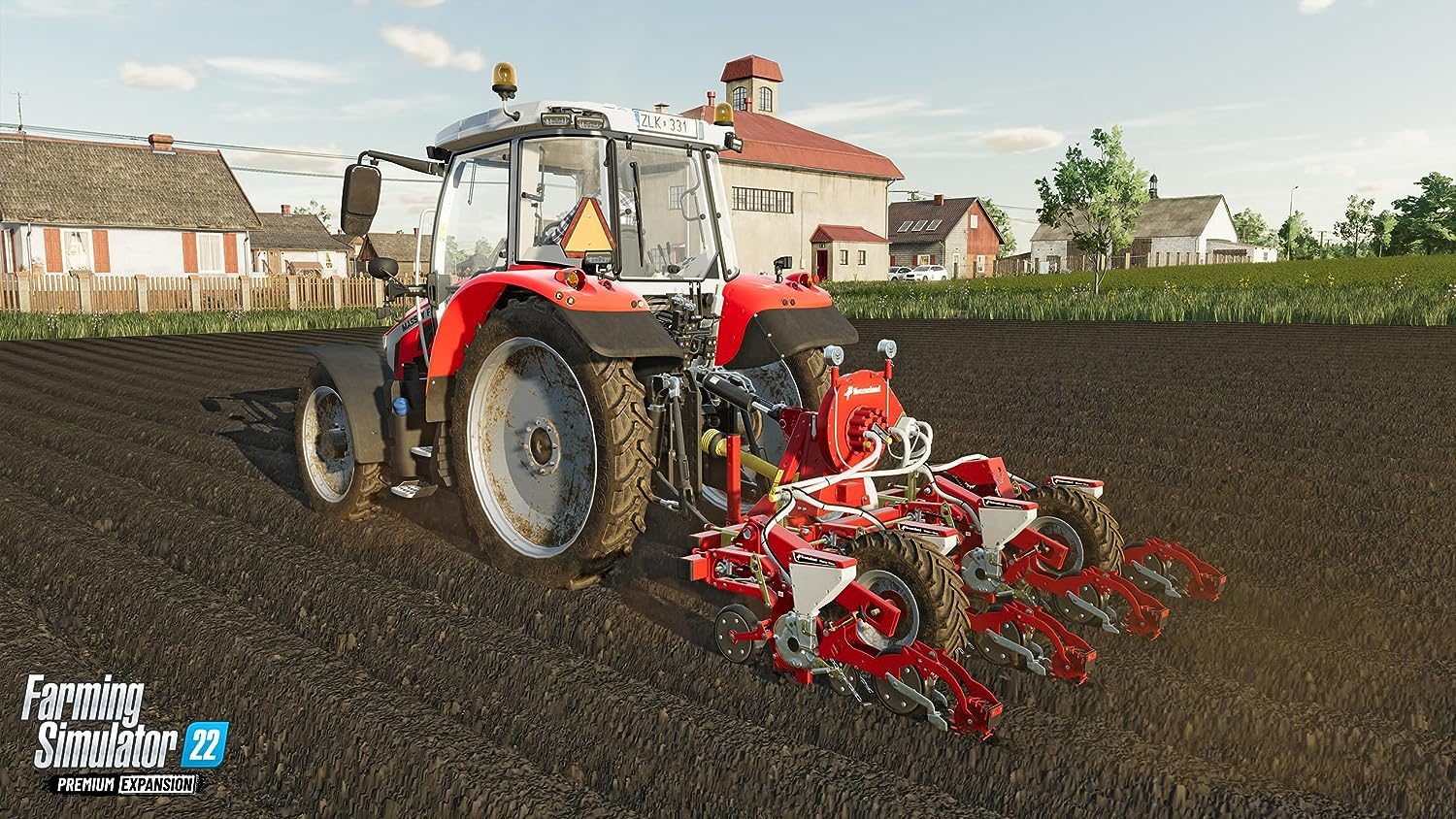 Un tractor rojo con una sembradora en un campo, Farming Simulator 22.