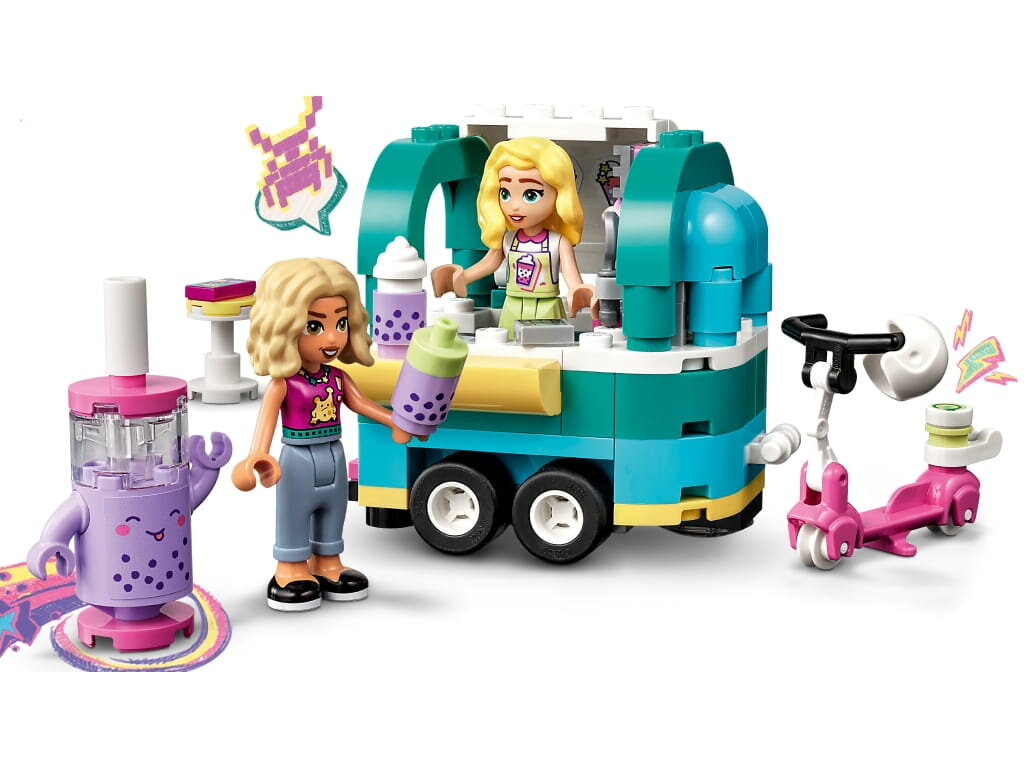Zestaw Lego z food truckiem i figurkami. Dwie figurki są w scenie. Skuter i napój z boku.