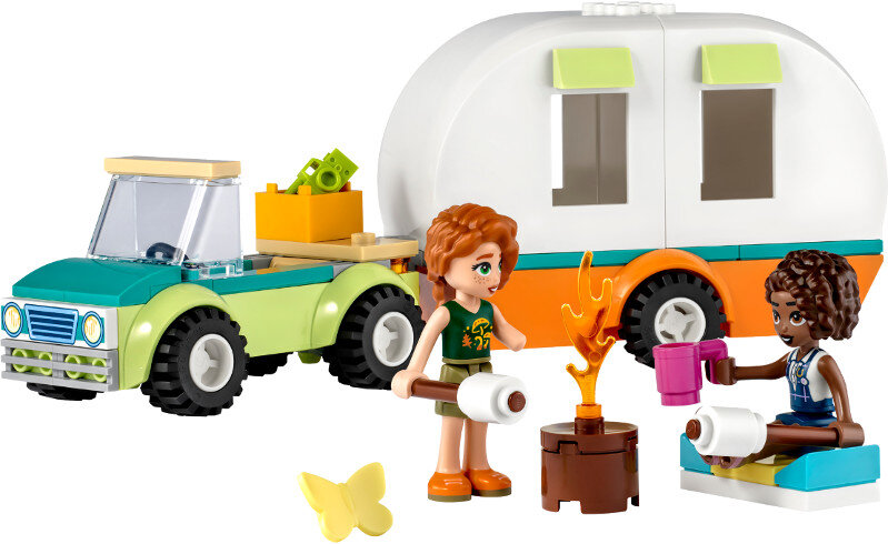 Scena Lego Friends: ciężarówka ciągnie przyczepę kempingową. Dwie dziewczyny pieką pianki.