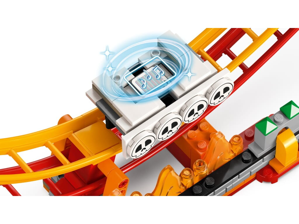 Tor kolejki górskiej Lego z wózkiem, czaszkami i grafiką nut. Użyto jasnych kolorów.