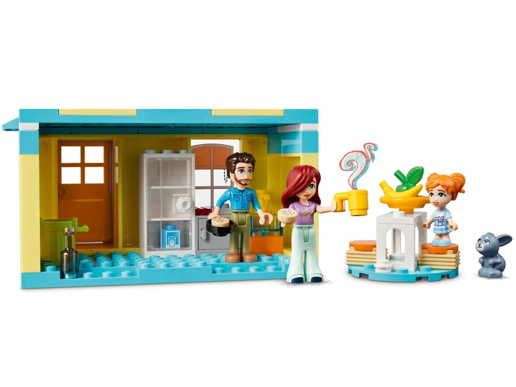 Zestaw Lego z figurkami rodziny i sceną gotowania w domu. Zawiera królika.