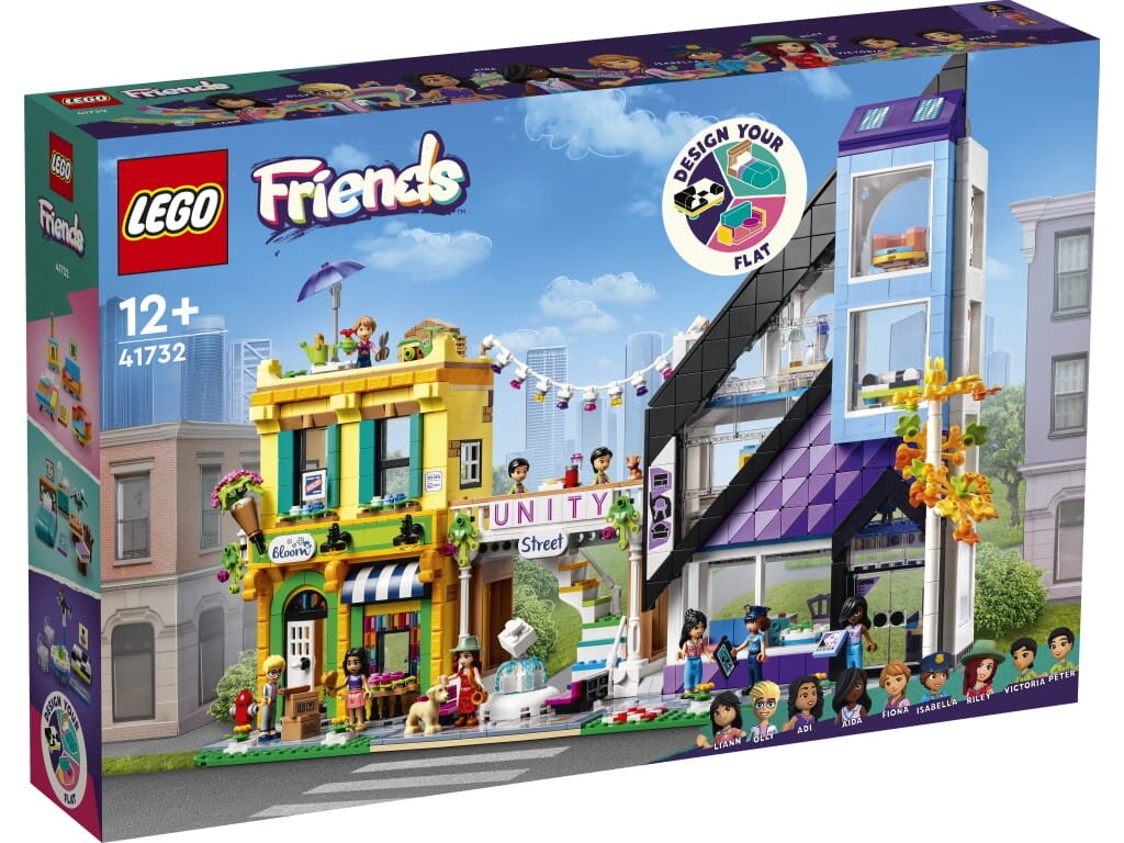 Zestaw klocków Lego Friends z kolorowymi budynkami, figurkami i sceną uliczną.