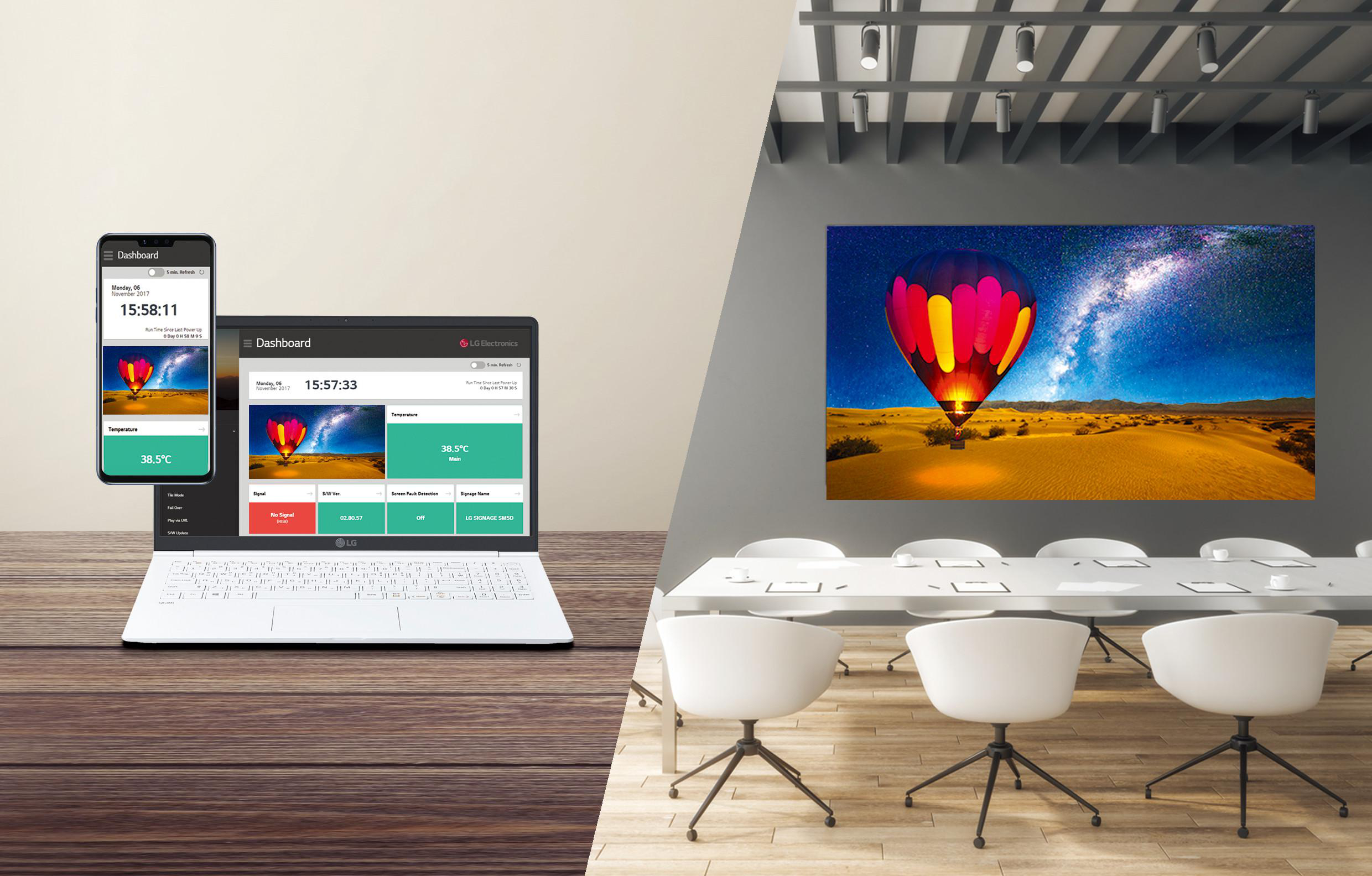 Ein Laptop, Telefon und Display zeigen eine Wüste mit Heißluftballon.