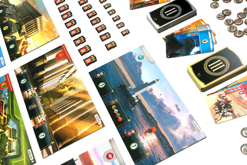 Gra planszowa z kartami, żetonami i krajobrazem miejskim.