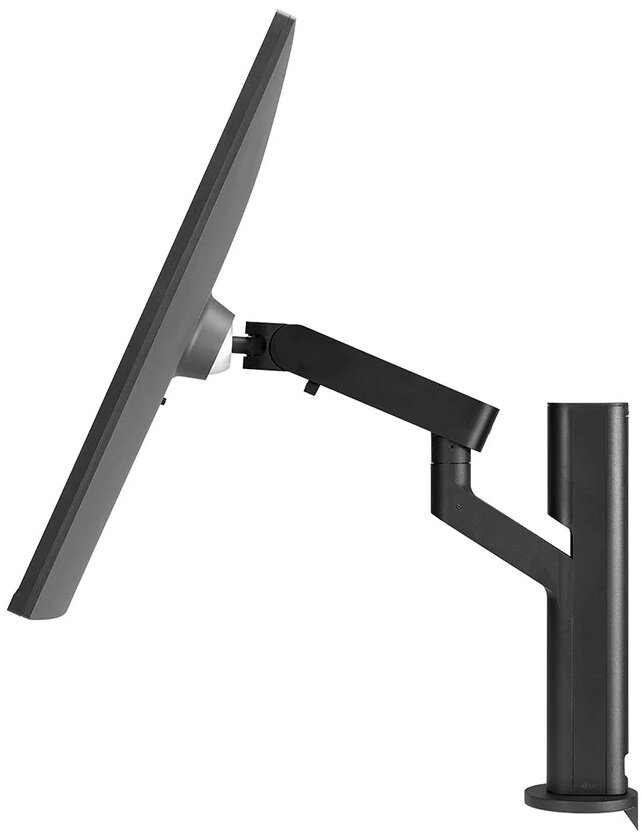 Czarny monitor komputera jest zamontowany na czarnym stojaku. Stojak jest przymocowany do białej powierzchni.