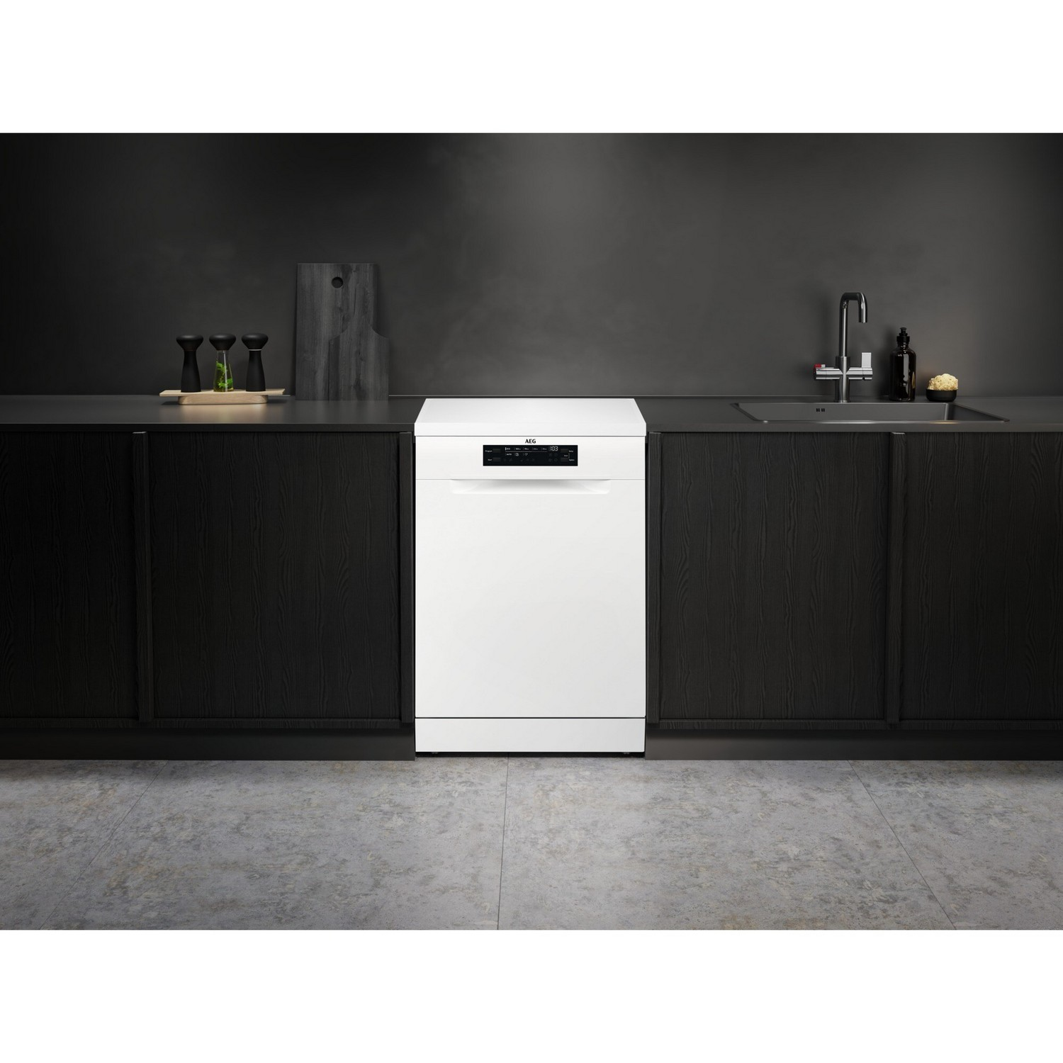White dishwasher in a kitchen. Black cabinets, gray countertop, and a sink.